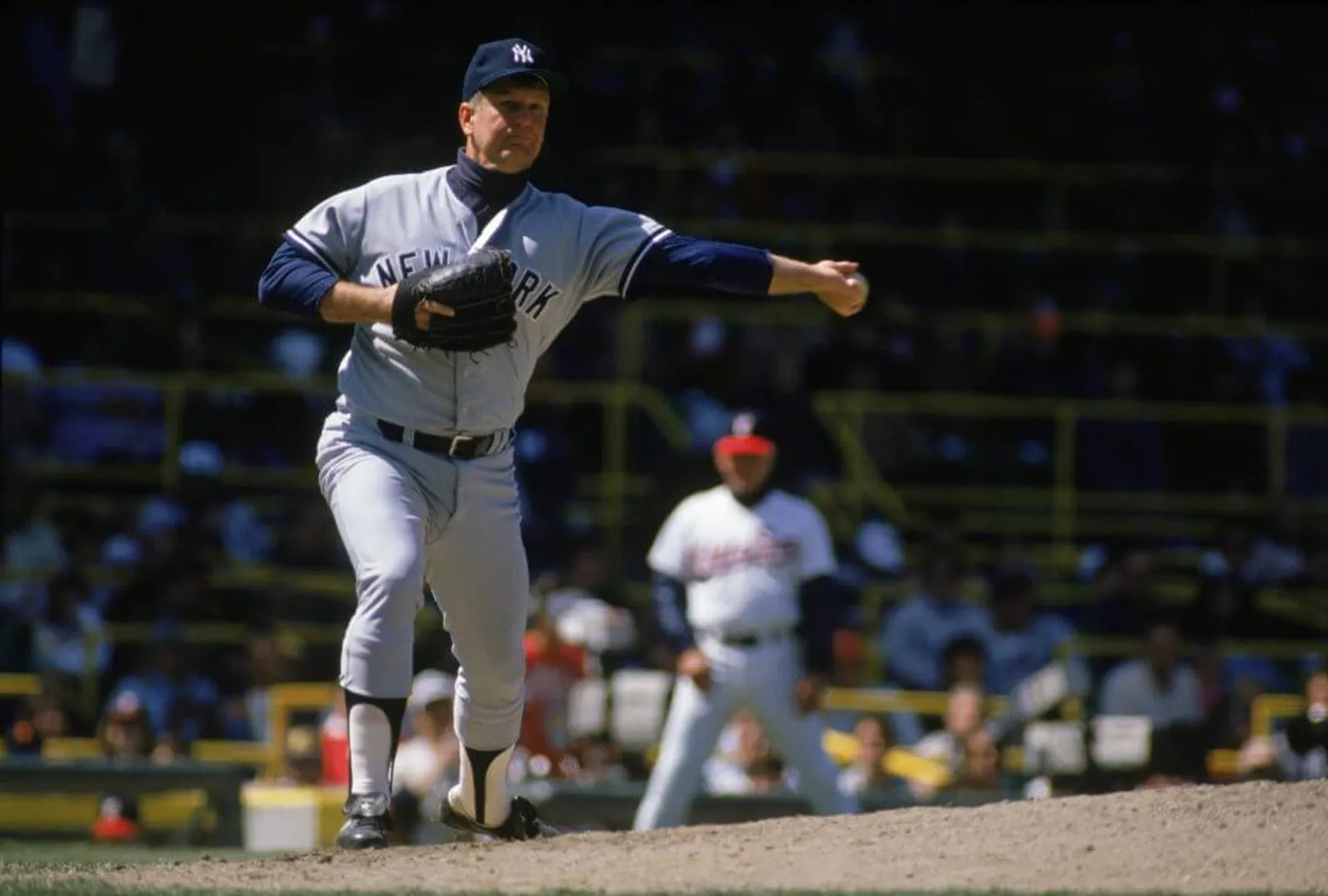 Tommy John throws to first base during a game in 1989.