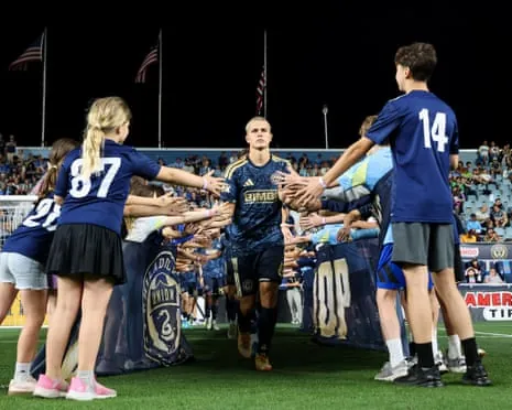 Cavan Sullivan of the Philadelphia Union jogs onto the field high-fiving young fans
